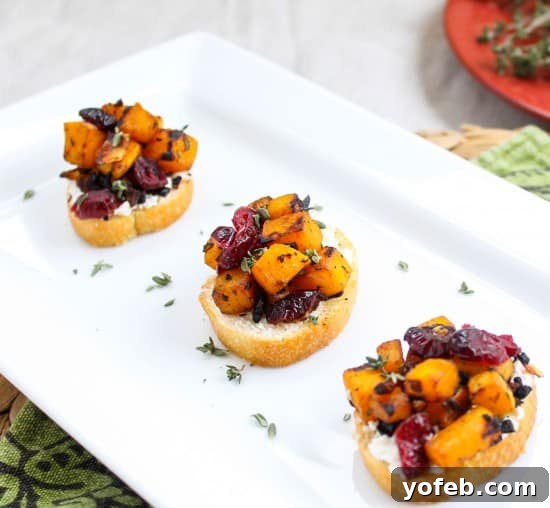 Roasted Butternut, Cranberry, and Chèvre Crostini 6 A hand reaching for a Butternut Squash, Cranberry, and Goat Cheese Crostini