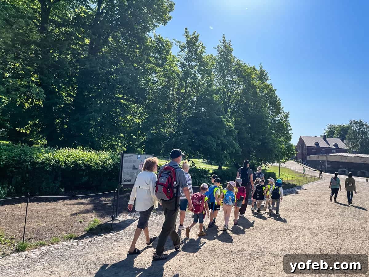 Unlock the Charm of the Baltics 13 Two adults playfully joining a line of children holding hands, set against a scenic backdrop.