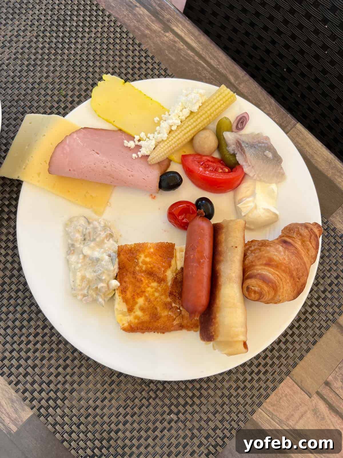 Unlock the Charm of the Baltics 14 A breakfast plate in Latvia featuring charcuterie, pastries, and various local delicacies.