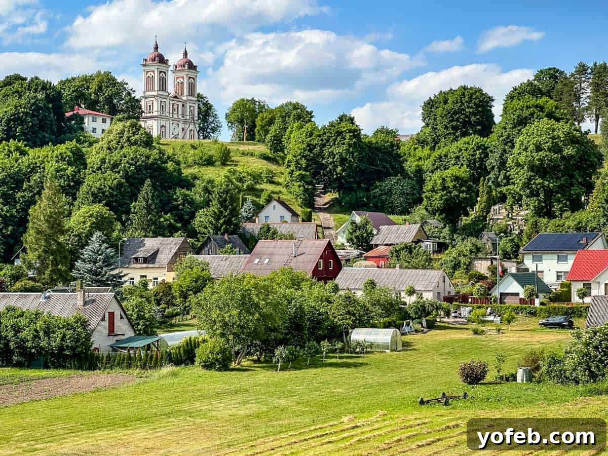 Unlock the Charm of the Baltics 5 Serene Lithuanian countryside featuring a traditional church with historical significance.