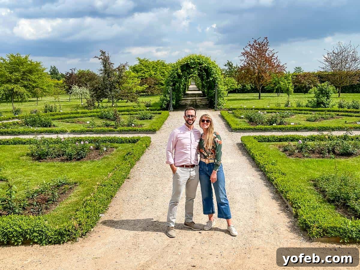 Unlock the Charm of the Baltics 51 A man and a woman standing in a meticulously manicured formal garden at Rundales Palace.