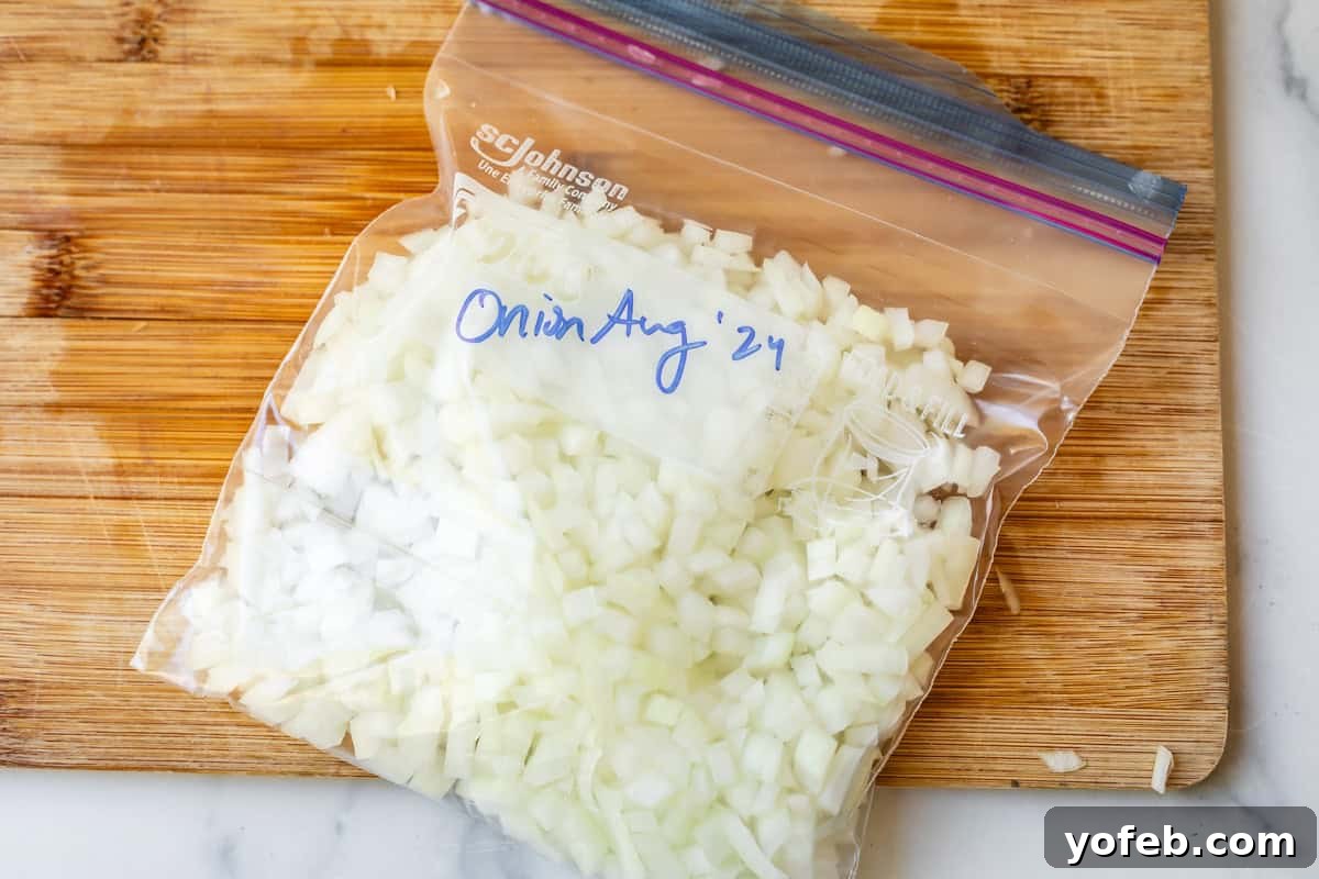 Chop Onions Like a Pro 18 quart size freezer ziplock bag filled with chopped onions and labeled onion Aug '24.