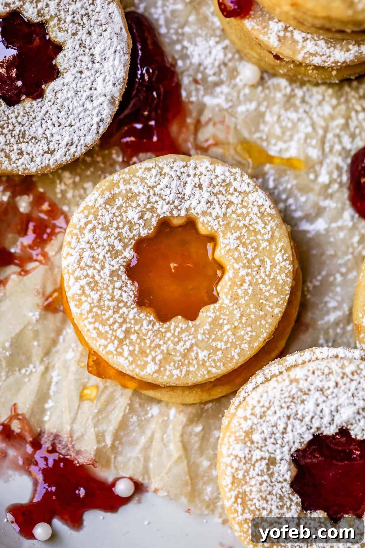Melt-in-Your-Mouth Linzer Delights 7 A cheerful Linzer cookie with a star cutout, beautifully filled with a sunny apricot jam, radiating warmth and flavor.