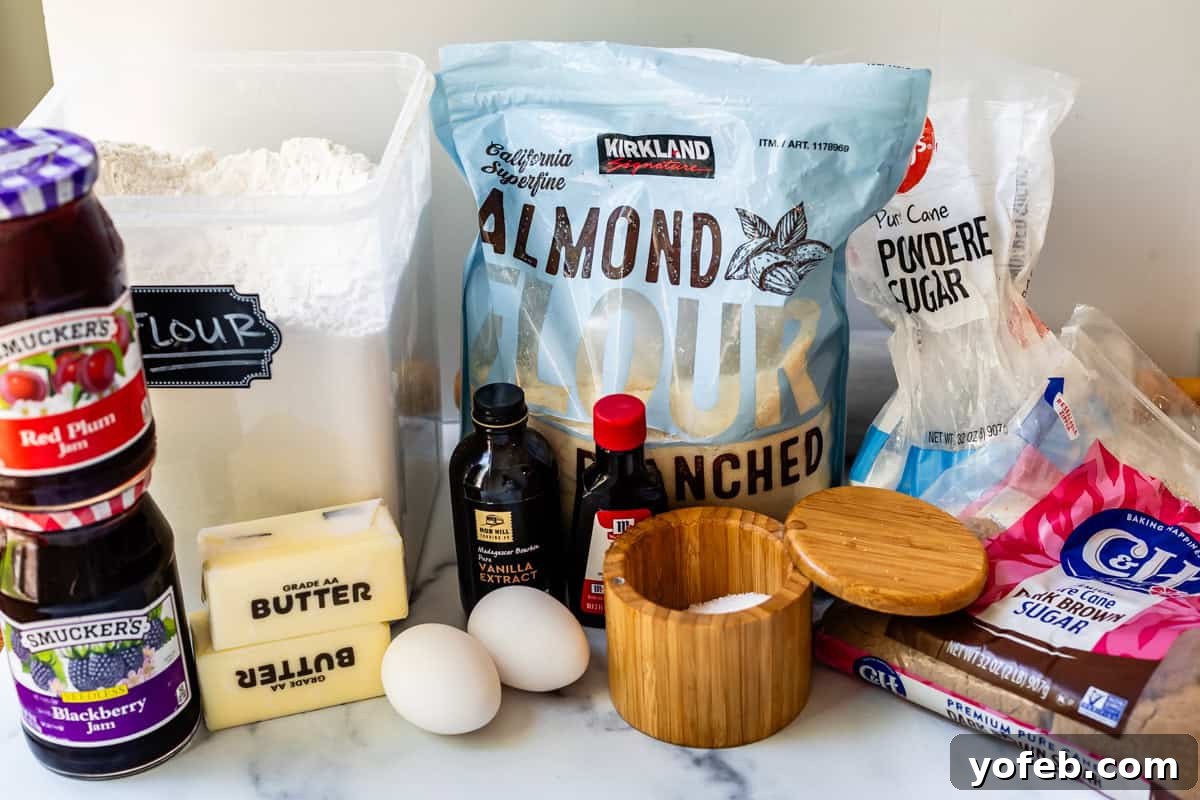 Melt-in-Your-Mouth Linzer Delights 8 A collection of essential ingredients for making Linzer cookies, including bags of almond flour and regular flour, sticks of butter, eggs, and other baking staples laid out neatly.