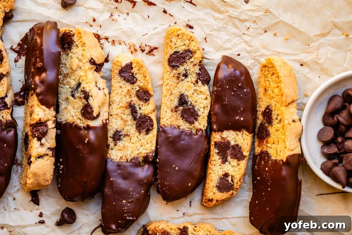 The Biscotti That Will Change Your Mind 6 Seven exquisite pieces of chocolate-dipped biscotti, neatly arranged on parchment paper, showcasing their perfect bake.