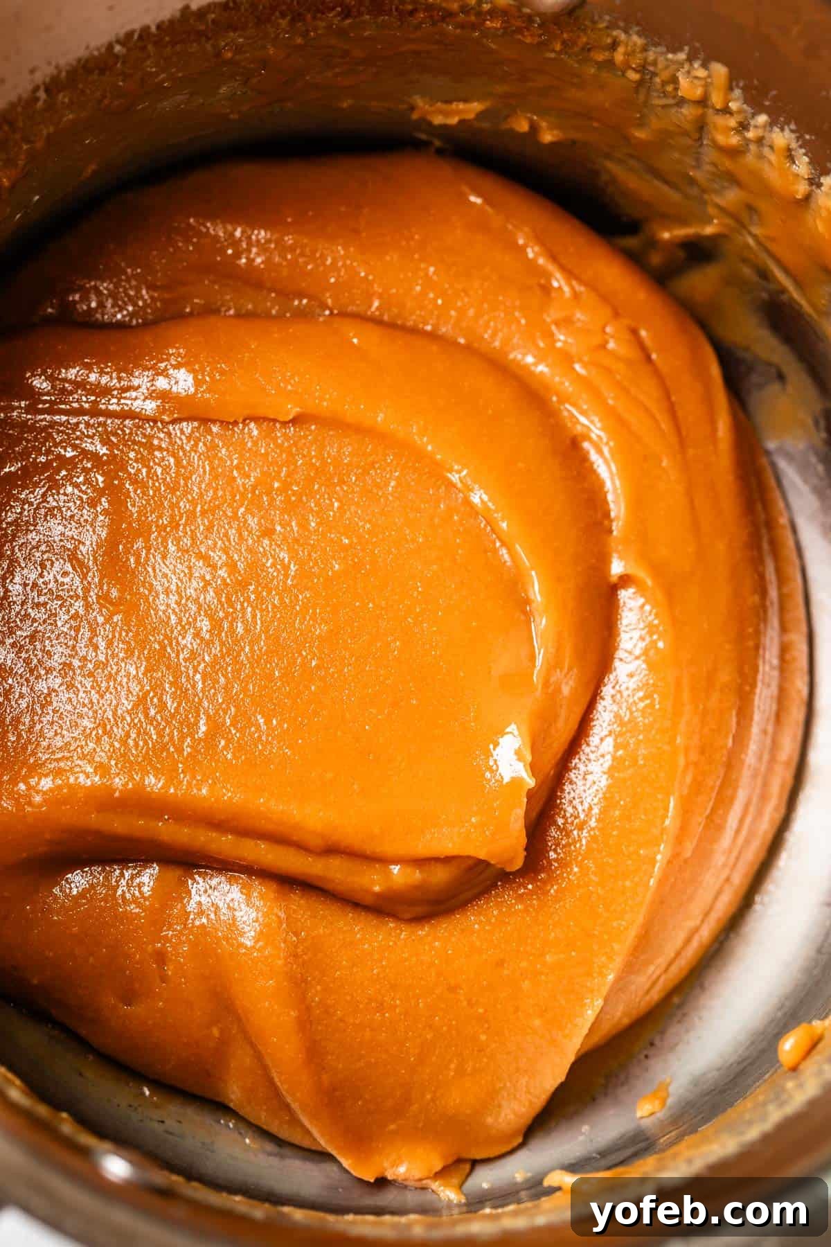 Dreamy Salted Caramel Sauce 6 A rich, golden salted caramel sauce rests in a metal bowl, highlighting its perfect, fudgy consistency.