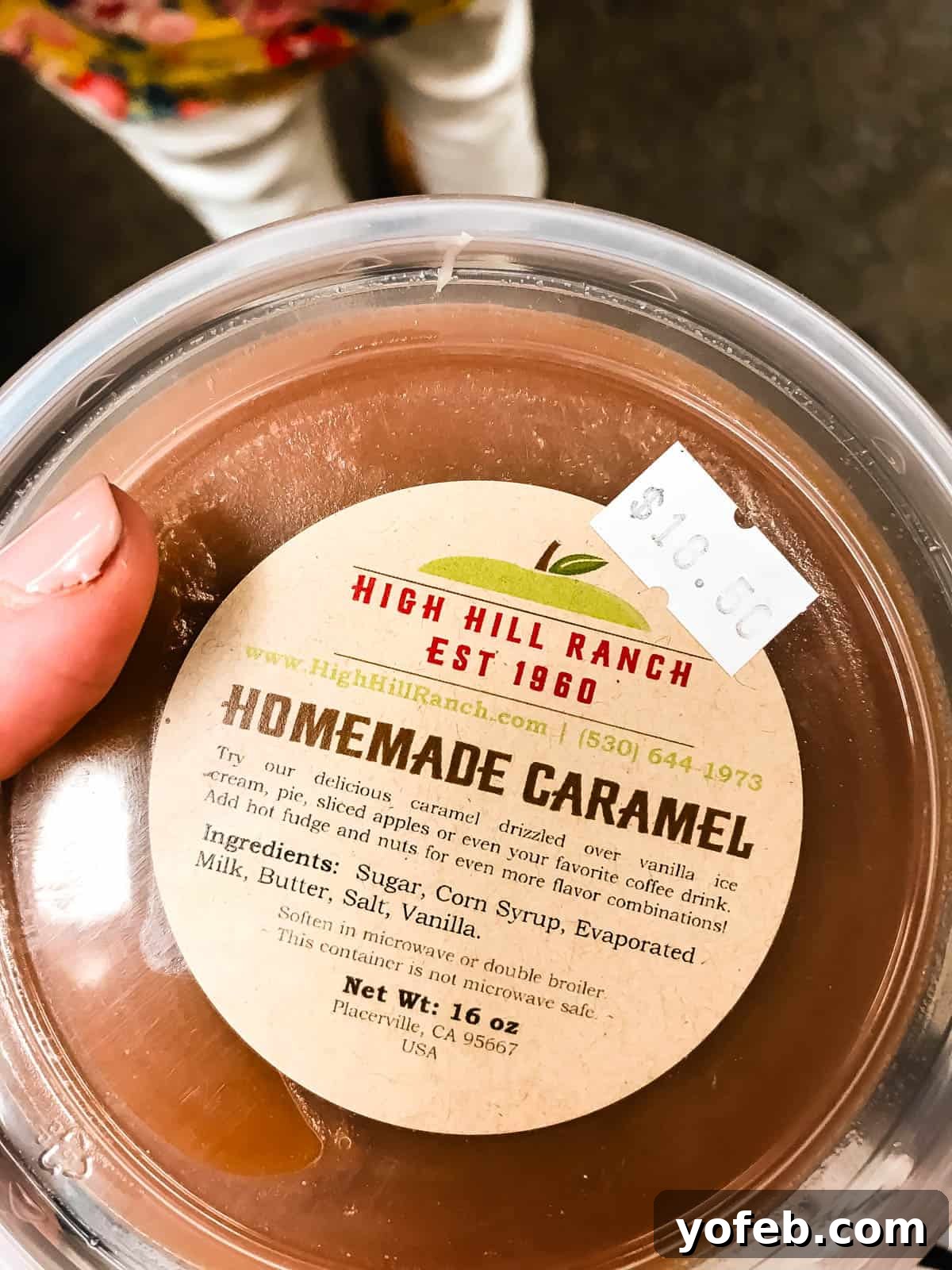 Dreamy Salted Caramel Sauce 7 A tub of homemade caramel, with its label visible, showing a hint of fudginess where the light catches the surface.