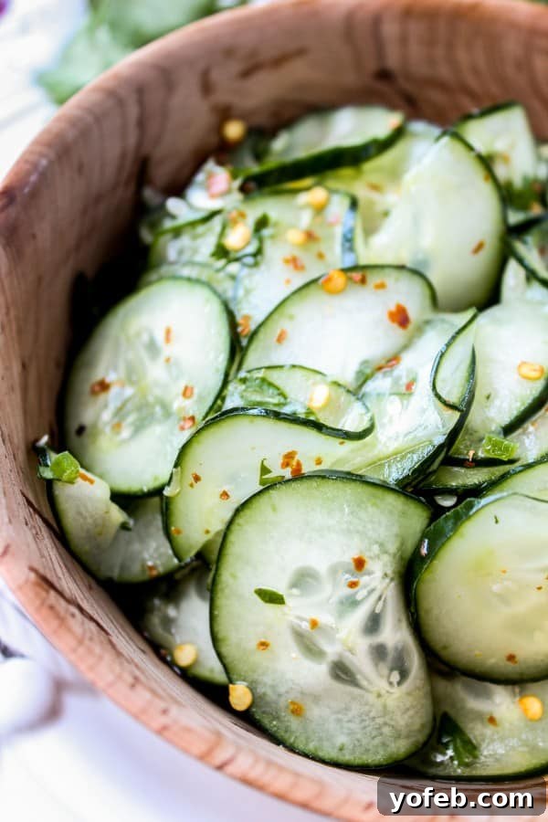 Cilantro Lime Cucumber Salad: Easy, Healthy, and Zesty Side for Mexican Food Fresh Mexican cucumber salad with cilantro and lime, served in a rustic wooden salad bowl, ready for a summer meal.