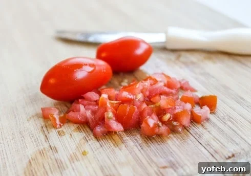 Finely minced roma tomato on a cutting board