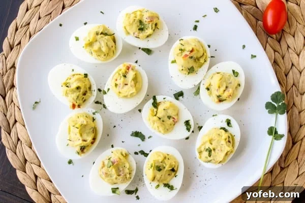 Close-up of Deviled Guacamole Eggs showing the vibrant green filling