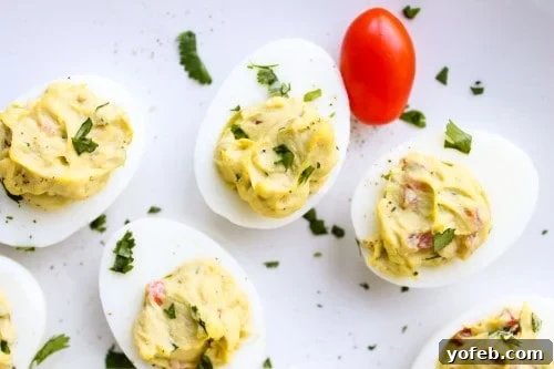 Plate of freshly prepared Deviled Guacamole Eggs garnished with fresh cilantro
