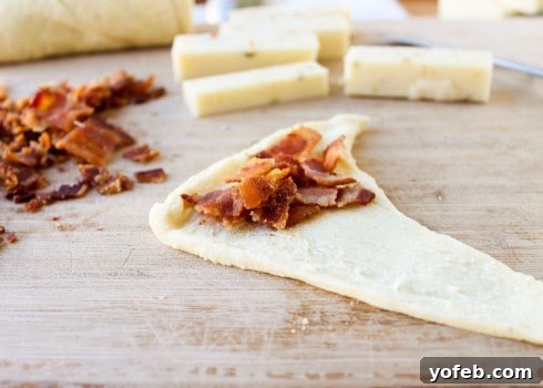 Spicy Bacon and Pepper Jack Crescent Rolls 11 Piling bacon onto crescent roll dough