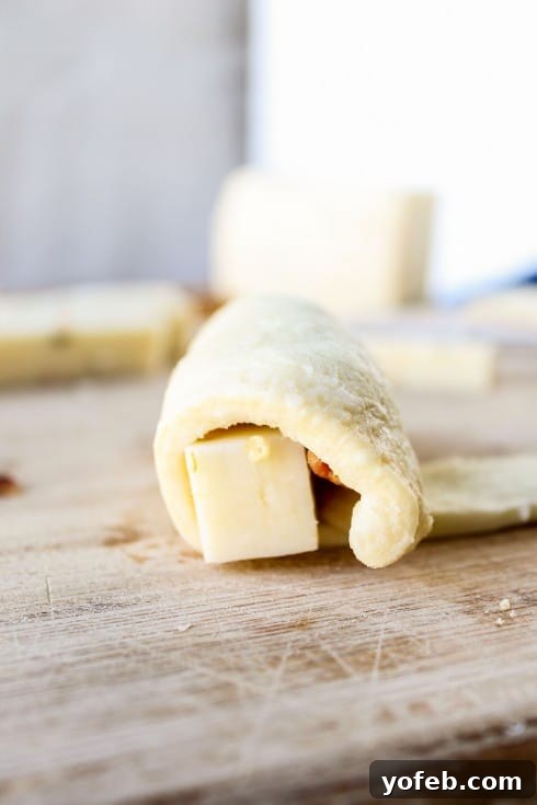 Spicy Bacon and Pepper Jack Crescent Rolls 14 Rolling up a crescent roll with filling