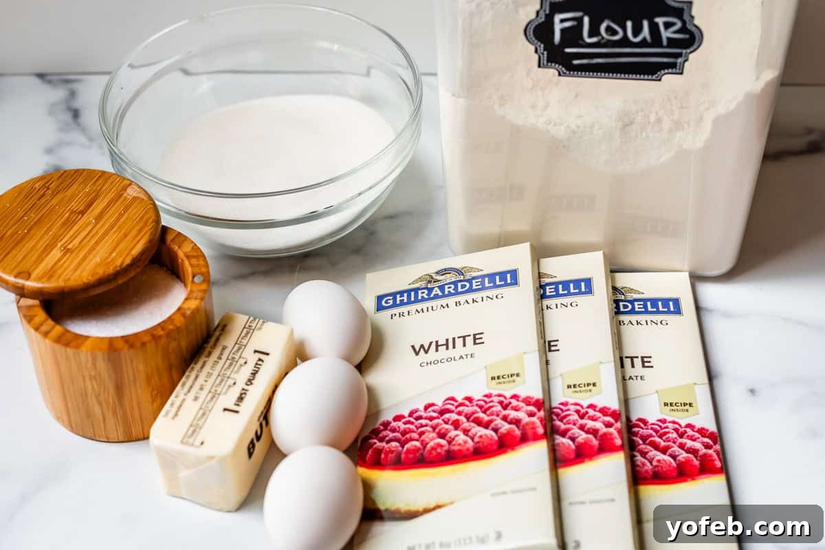 Irresistible White Chocolate Brownies 11 A flat lay of all the essential ingredients for making white chocolate brownies, including white chocolate bars, eggs, flour, butter, and sugar.