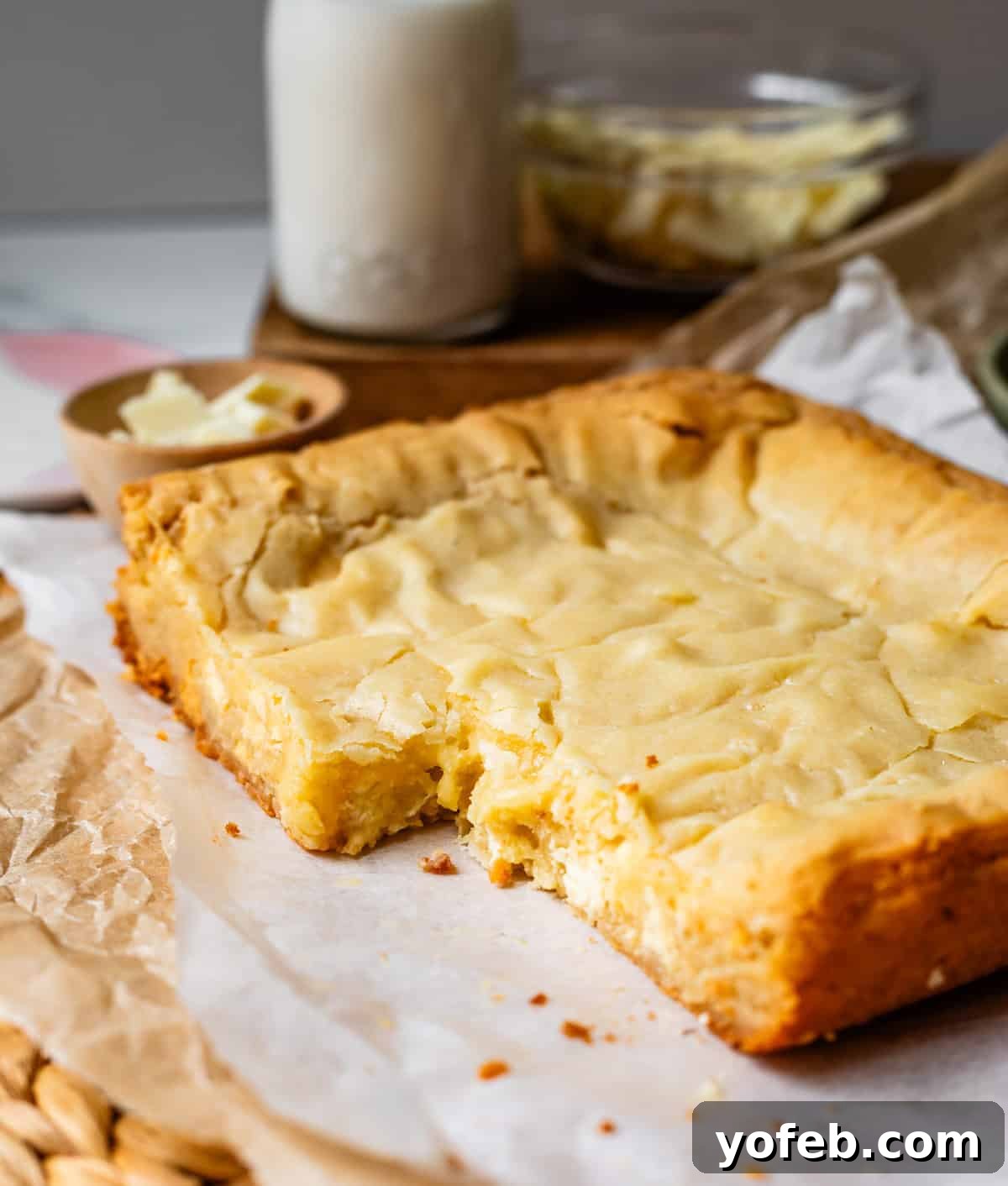 Irresistible White Chocolate Brownies 19 Freshly baked white chocolate brownies in a pan with a section cut out, revealing their soft, fudgy interior.