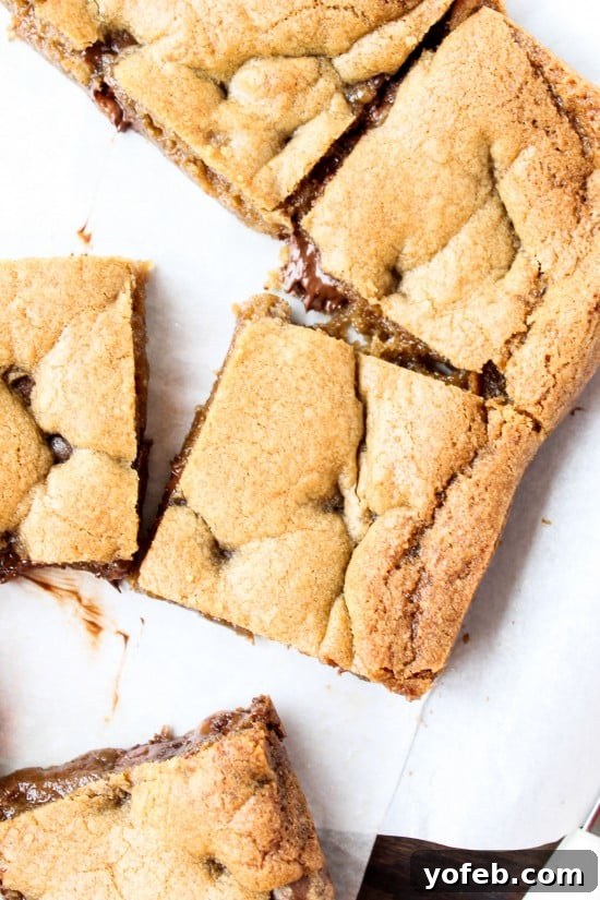 Browned Butter Blondies Swirled with Sea Salt Butterscotch Caramels 5 Close-up shot of a browned butter blondie with a visible butterscotch caramel pocket, emphasizing its gooey center.