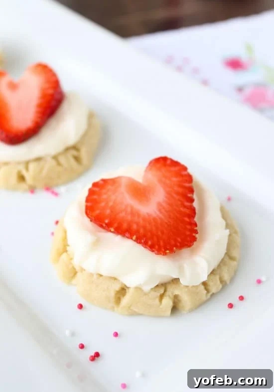 Sweetheart Cookies with a Snowy Coconut Crown 3 Coconut-Frosted Sugar Cookies with Strawberry Hearts - Close Up