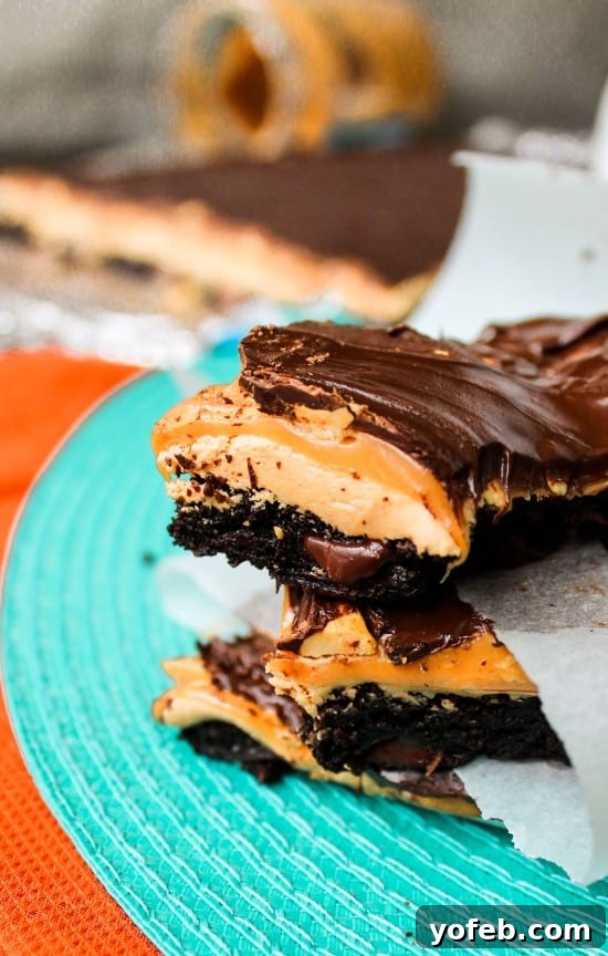 Ultimate Snickers Brownie Treat 5 Decadent homemade Snickers Brownie Bars ready to be devoured