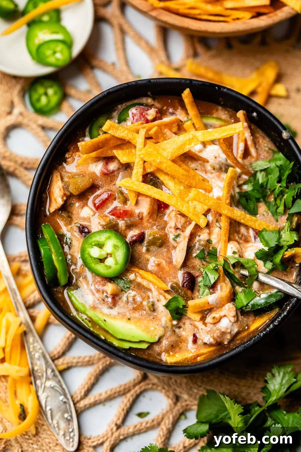 No-Fuss Chicken Tortilla Soup 5 a bowl of tortilla chicken soup looking more creamy because of sour cream mixed in.