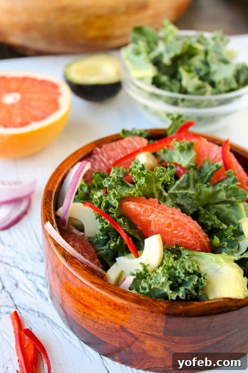 Zesty Avocado & Ruby Grapefruit Medley 10 Kale, Avocado & Grapefruit Salad perfectly mixed in a large bowl, showcasing its readiness to be served