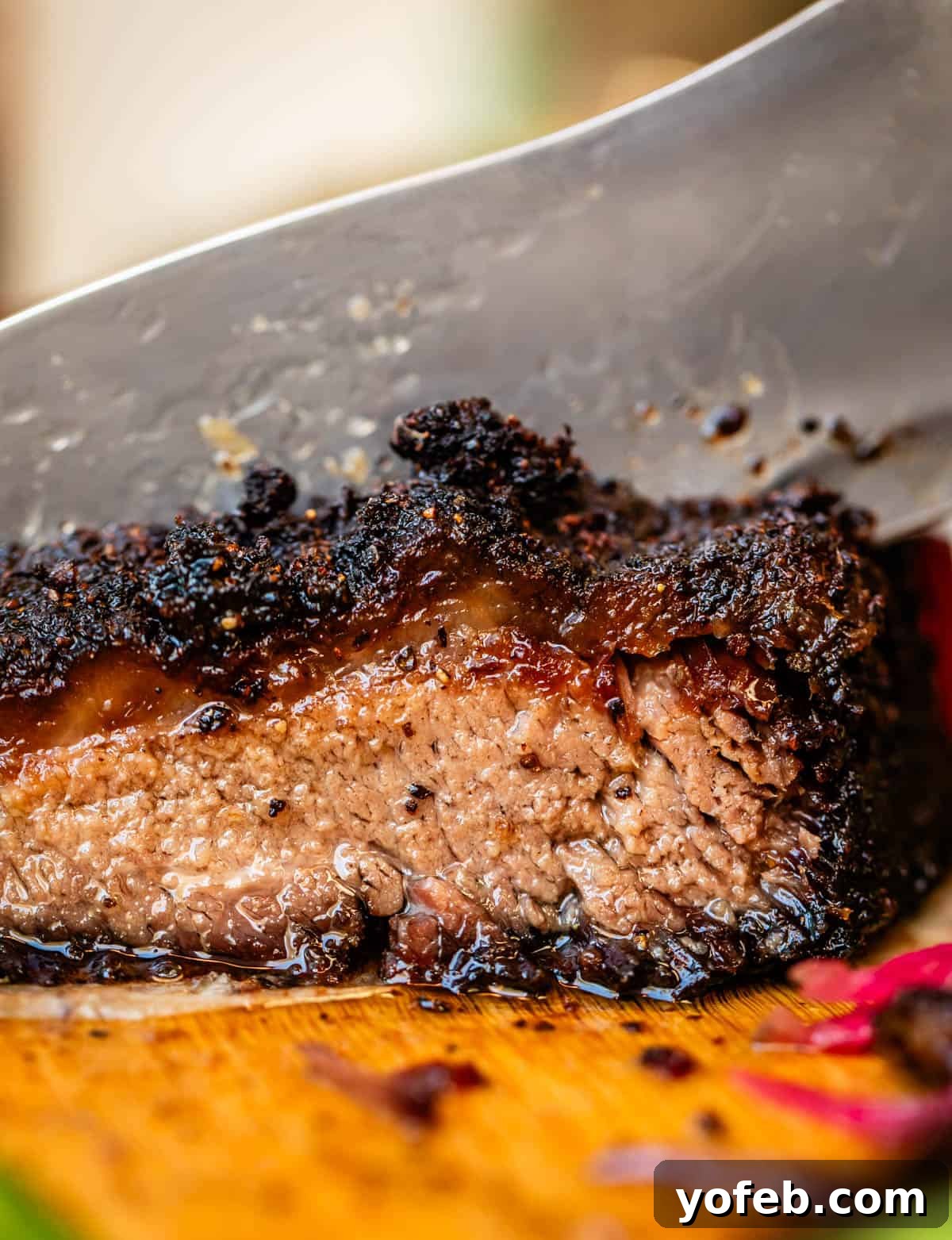 Texas Brisket: Oven-Perfected Tenderness 2 Slicing through moist beef brisket with charred fat cap.
