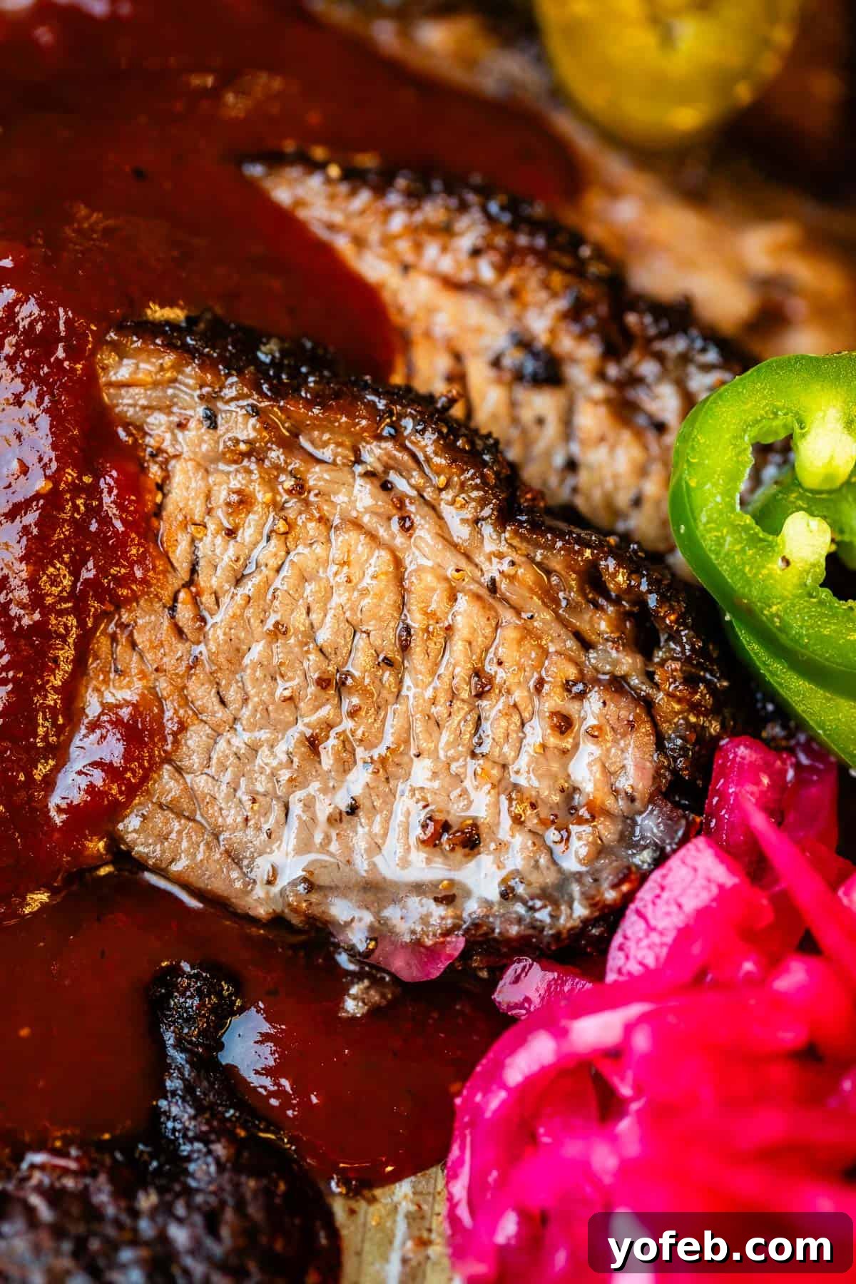 Texas Brisket: Oven-Perfected Tenderness 3 Juicy slices of beef brisket with bbq sauce drizzled on with jalapeño and pickled onions.