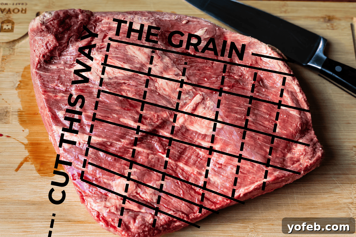 Texas Brisket: Oven-Perfected Tenderness 32 brisket on a cutting board with lines added to show the direction of the grain.