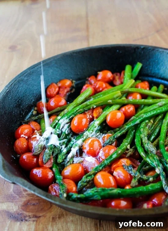 Crisp Asparagus and Tomato Medley 5 Rich cream gently drizzles into a cast iron pan, mixing with bright green asparagus and ruby-red cherry tomatoes.