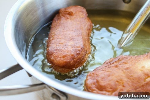 Simple 30-Minute Maple Bars 15 Flipping a Maple Bar dough in hot oil