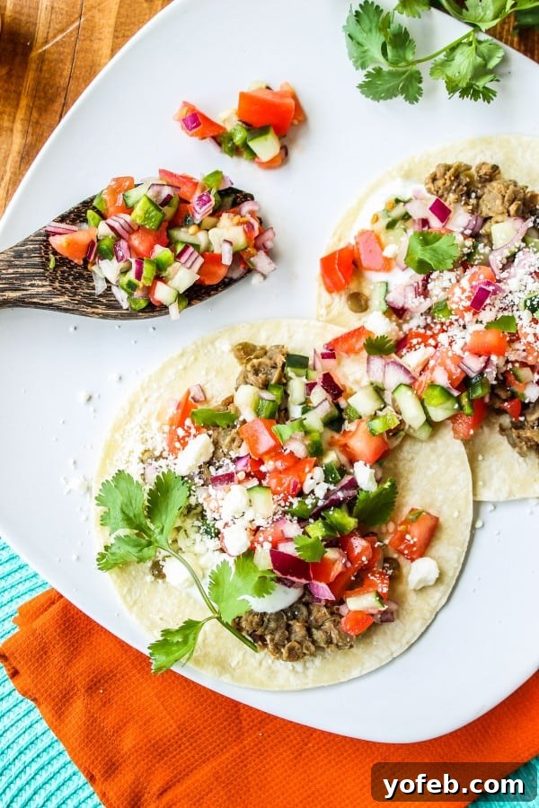 Zesty Greek Lentil Tacos with Cool Cucumber Pico 3 Close-up of a finished Greek Lentil Taco, showing the rich lentil filling and fresh toppings.