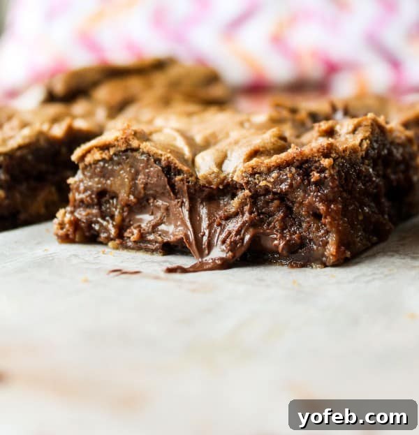 Decadent Browned Butter Blondies with a Gooey Nutella Heart 10 The prepared blondie batter with Nutella dollops pressed into it, showcasing the readiness for the oven.
