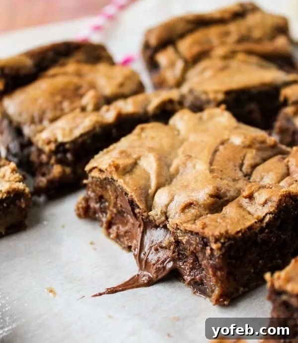 Decadent Browned Butter Blondies with a Gooey Nutella Heart 2 Nutella-Stuffed Browned Butter Blondies: The ultimate decadent dessert featuring rich browned butter and gooey Nutella pockets.