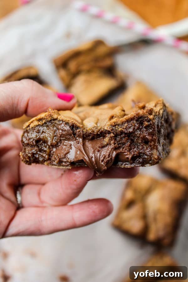 Decadent Browned Butter Blondies with a Gooey Nutella Heart 3 Humorous depiction of the 'Gnutella' spelling debate, showcasing the irresistible charm of Nutella-stuffed desserts.
