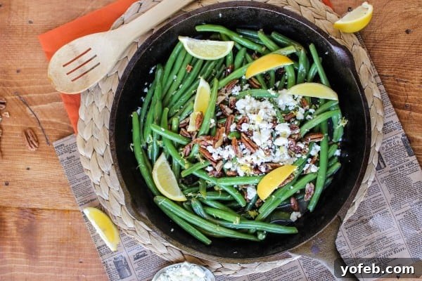 Zesty Green Beans with Creamy Feta and Crispy Pecans 7 Freshly cooked green beans tossed with lemon and herbs, ready for feta and pecans.