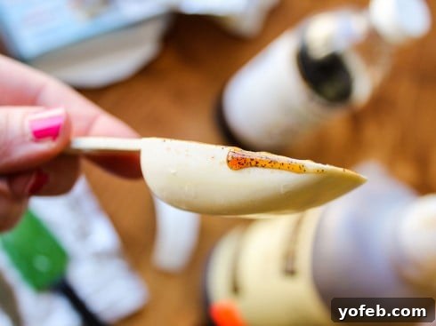 Effortless Cheesecake Parfait Station 18 A close-up of a spoon showing vanilla bean paste with its visible specks