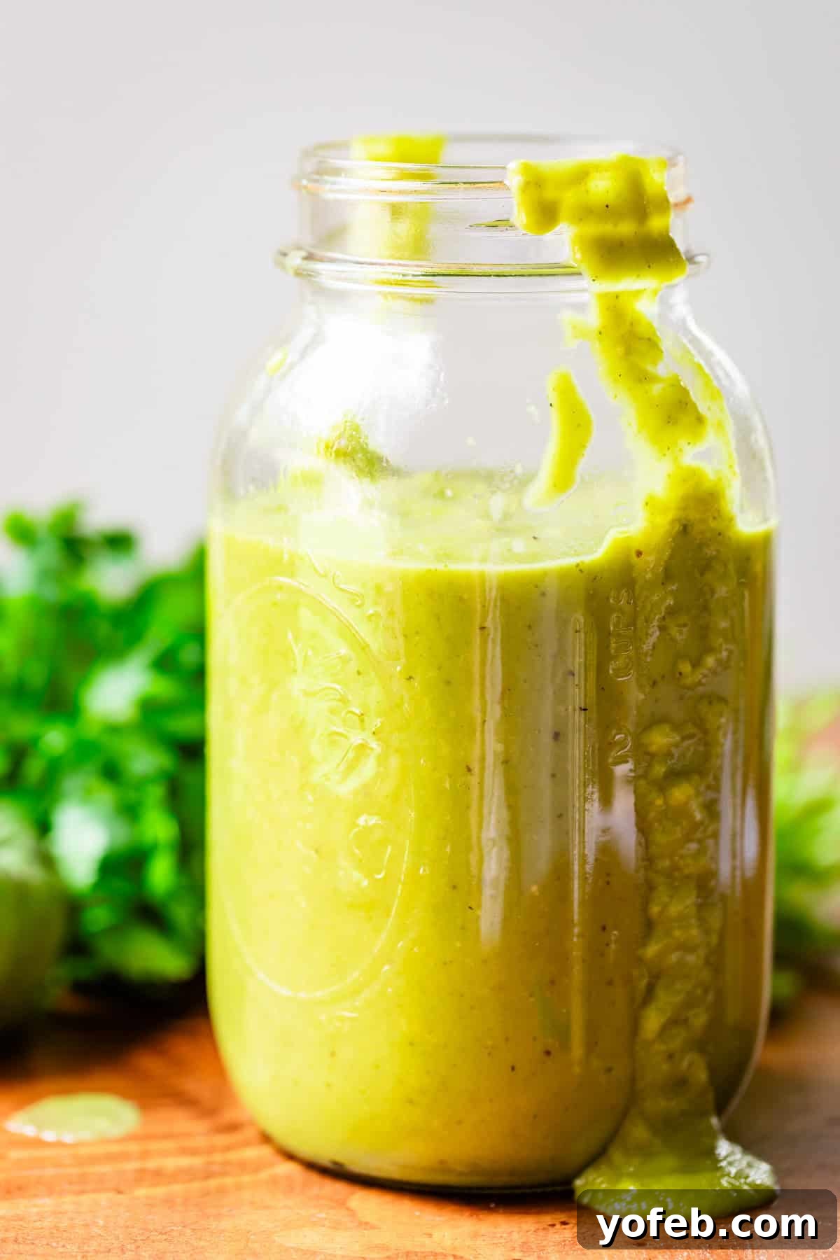 Tangy Tomatillo Enchilada Sauce 3 a quart sized mason jar filled 3/4s of the way with green enchilada sauce.