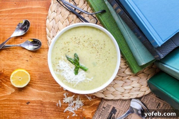 Vibrant Spring Asparagus Puree 5 Overhead view of asparagus soup, with fresh lemon and spoons, suggesting a light and flavorful dish.