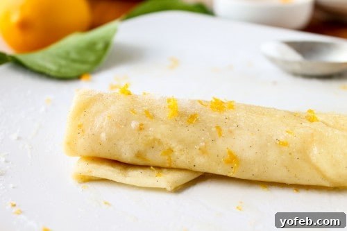 Zesty Meyer Lemon & Cardamom Crepes 9 rolled up crepe sprinkled with sugar, lemon zest, and cardamom spice.