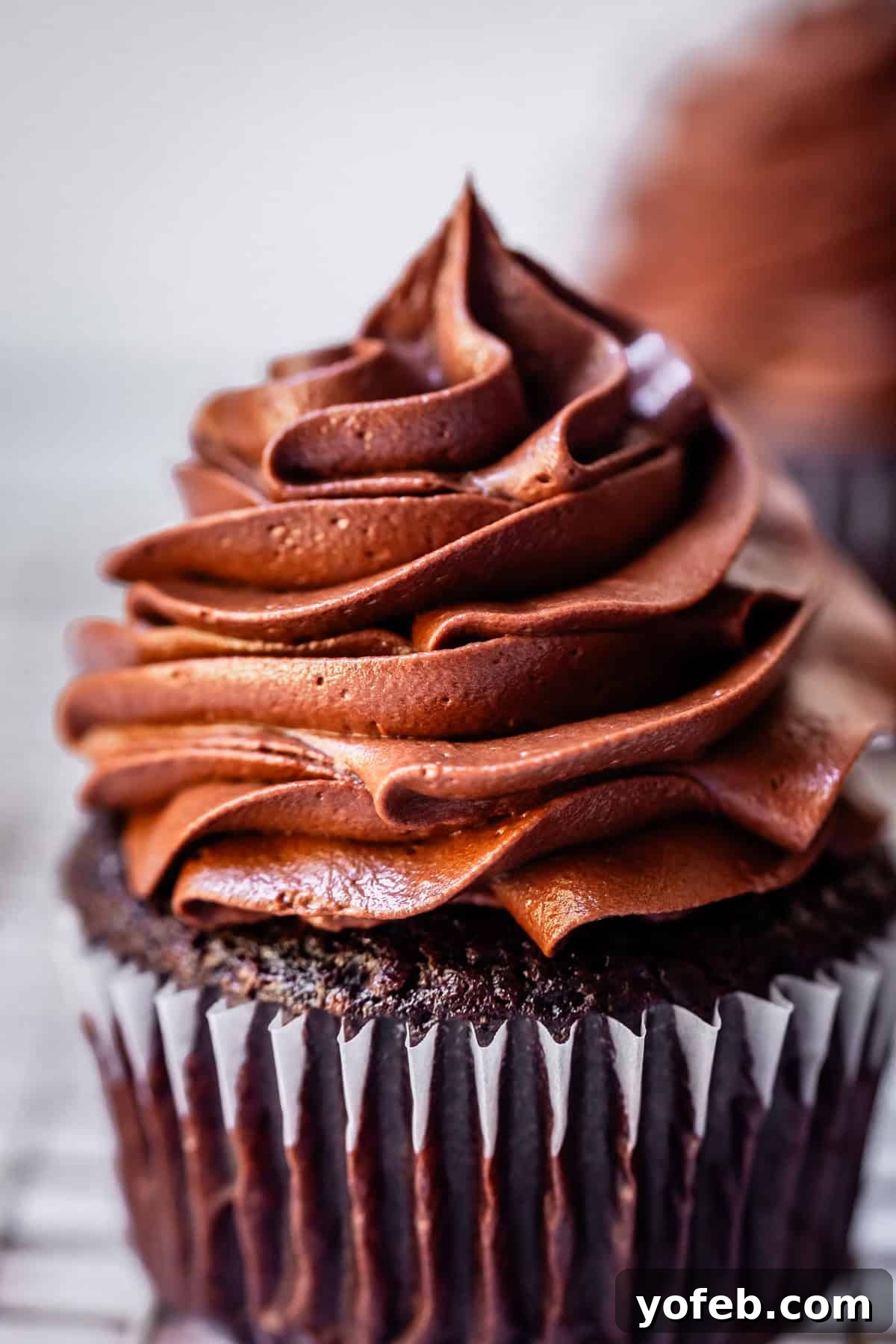 Luscious Chocolate Buttercream: Spoon-Licking Guaranteed 15 perfectly piped chocolate frosting atop a chocolate cupcake in a paper liner.