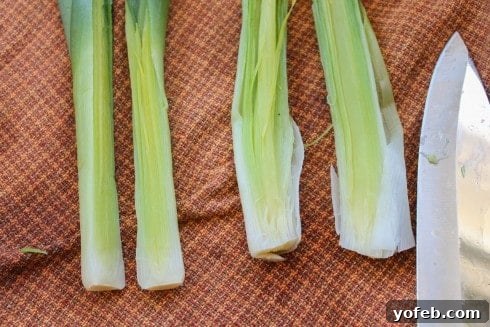 Boiled leeks cooling on a towel, ready for final cut