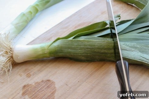 Chopping off the top green portion of the leeks