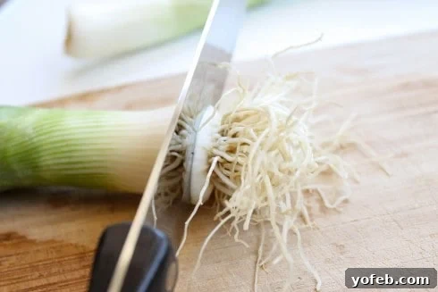 Trimming the root end of the leeks for grilling