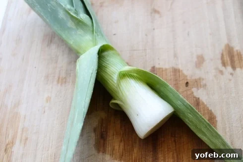 Peeling off tough outer layers of a leek