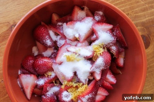 Lemon Berry Bliss 9 Lemon strawberry mixture in bowl with sugar and zest, ready for maceration