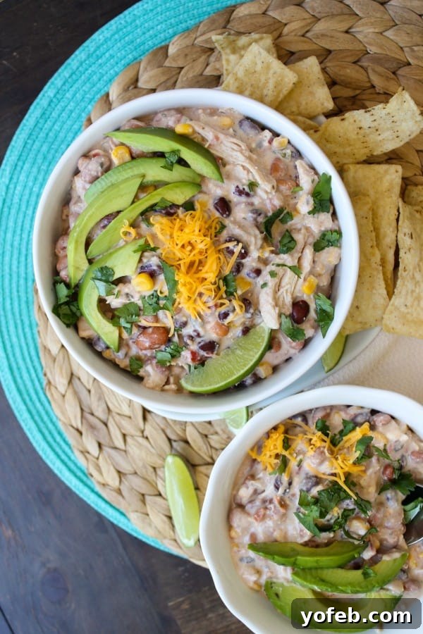 Stirring Cream Cheese Chicken Chili in a crockpot