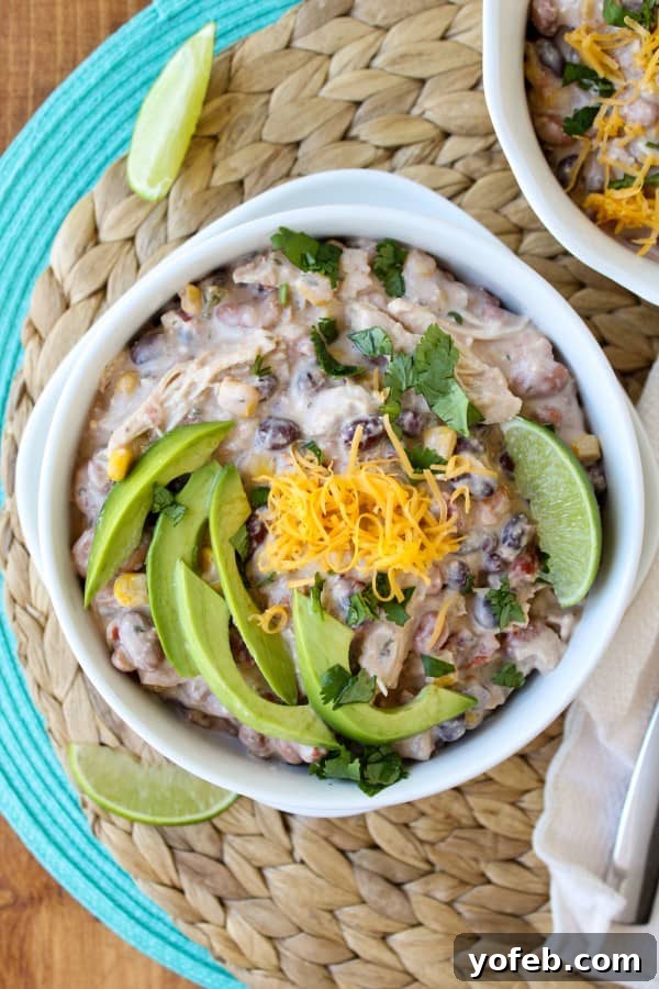 A serving of Cream Cheese Chicken Chili with garnishes