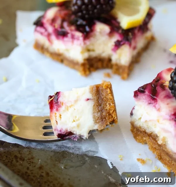 Zesty Lemon Blackberry Squares 4 A close-up shot of a blackberry lemon cheesecake bar with a fork taking a bite, showing the layers of crust, cheesecake, and fruit swirl.