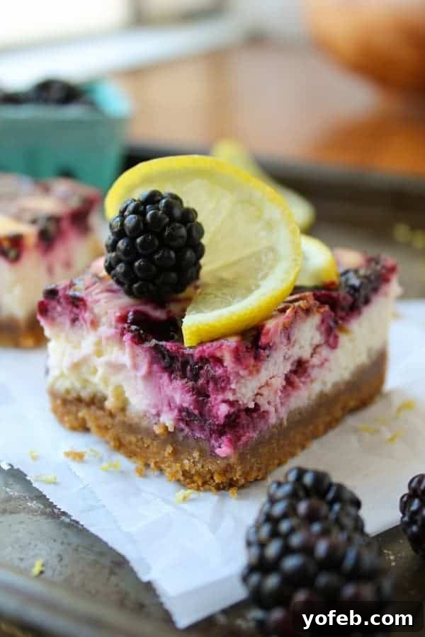Zesty Lemon Blackberry Squares 8 A thick crust blackberry lemon cheesecake bar on parchment paper, emphasizing the substantial base.