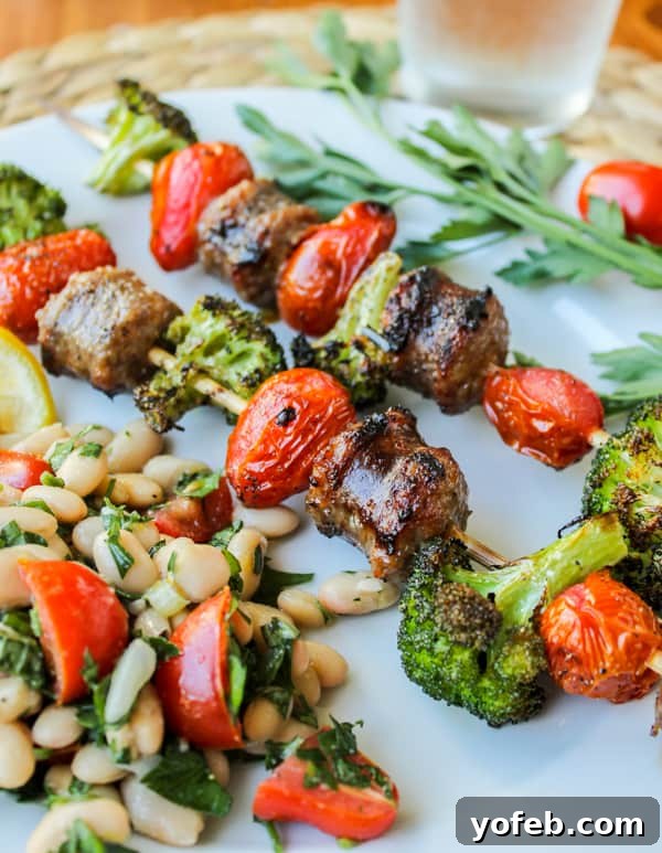 Quick Sausage & Broccoli Skewers with Zesty White Bean Salad 2 Easy Sausage and Broccoli Kebabs with White Bean Salad on a plate