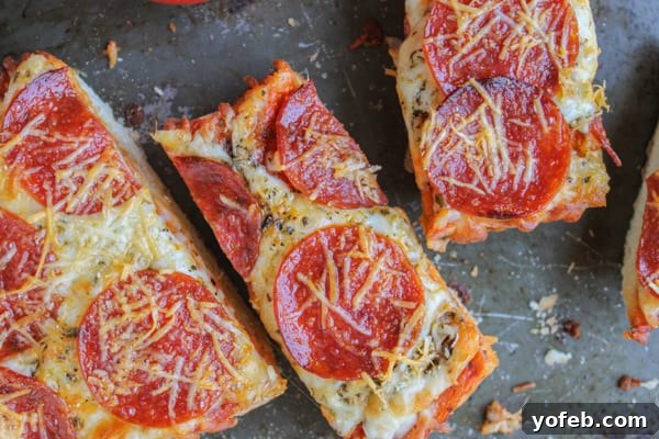 Triple Threat French Bread Pizza 5 A selection of French Bread Pizzas, hot out of the oven, ready to be sliced and served.